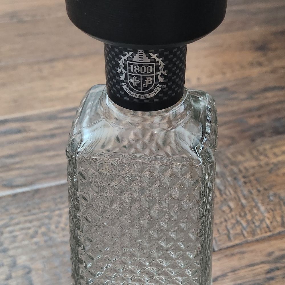 Elegant Clear, Empty Glass Bottle with Black Cap